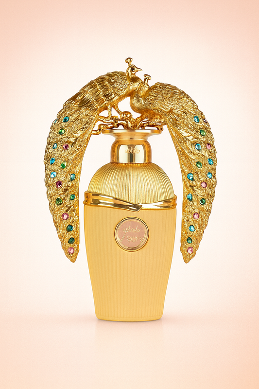 Perfume de lujo dorado con diseño de pavos reales y detalles de gemas multicolor